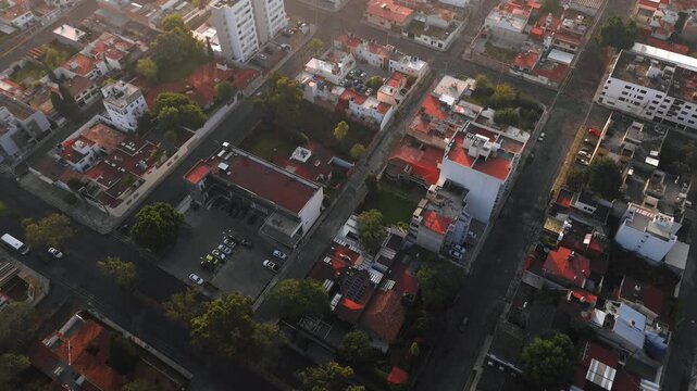 La Paz, Puebla, Mexico, residential area, neighborhood, aerial view, drone pov, sunset, golden hour, houses, apartment buildings, red tile roofs, traditional architecture, trees, green neighborhood, r
