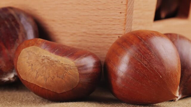 Fresh chestnut, supermarket food, Oven roasted chestnuts with sliced peel on wooden board, spanish traditional winter dish.