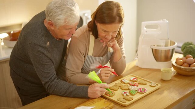 Happy family Christmas festive holiday celebration. Senior parents and adult daughter preparing and decorating holiday cookies together. Caucasian family enjoy festive treats in the kitchen.