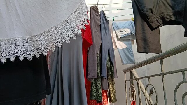 Hanging Clean Clothes on a Clothesline to Dry Outdoors