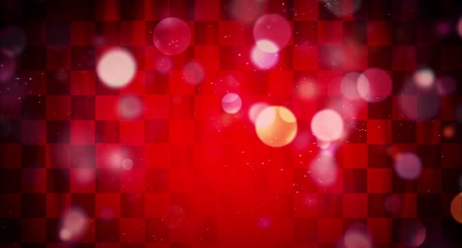 Red particles float and sparkle in cinematic motion on a dark red background 
