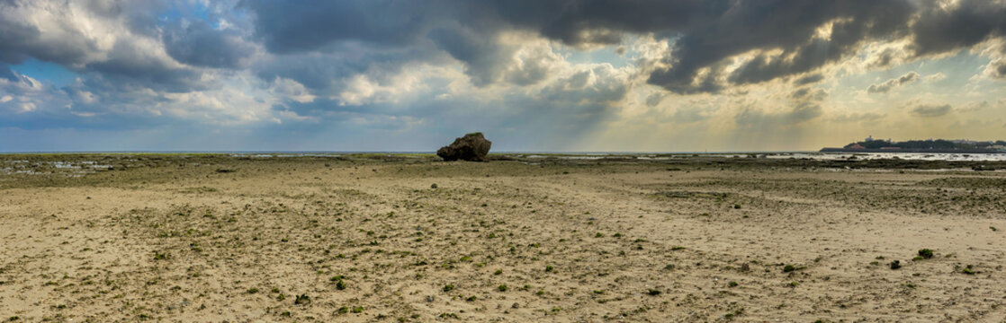 Dramatic sun rays over tropical coral reef and tidal flat at low tide in Okinawa Japan