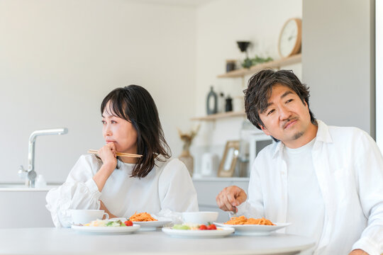 Couple in Their 40s Experiencing Tension During a Meal, Struggling with Marital Conflict and Communication