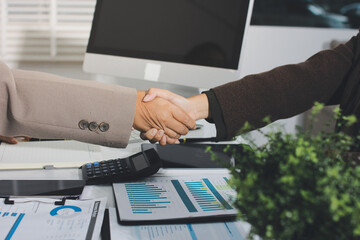 Business people shaking hands finishing up a meeting. Two confident businessman shaking hands during a meeting in the office, success, dealing, greeting and partner concept. © Natchanida