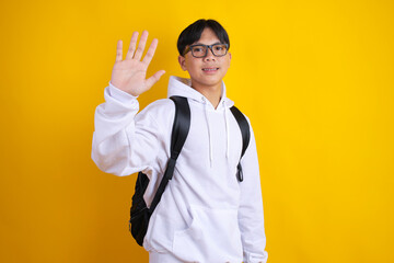 Friendly Teenage Student with Backpack Giving High Five or Waving Hello Sign © Gatot