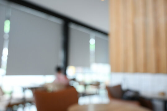 softy blurred view of a modern cafe or lounge interior featuring comfortable chair and round table