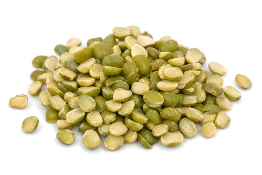 A pile of split green moong dal legumes isolated on a white background for healthy cooking ingredients
