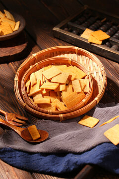 Crispy seasoned rice crackers in a bamboo basket