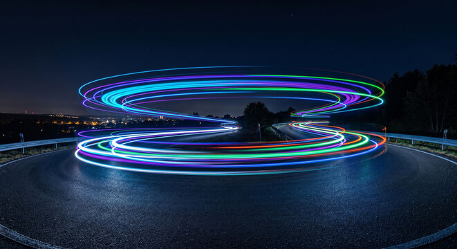 Long exposure light trails of traffic on a curved highway leading to the city skyline at night, Night traffic on a busy freeway with red and white blurred light streaks and cityscape.