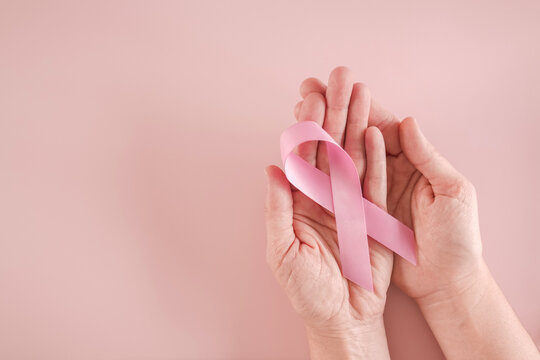 hands holding pink ribbons, Breast cancer awareness and October Pink day, world cancer day