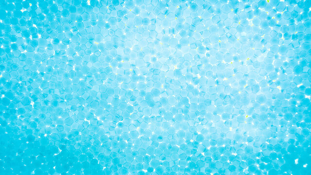 Abstract blue plastic foam texture pattern illuminated with light for background and modern banner design.