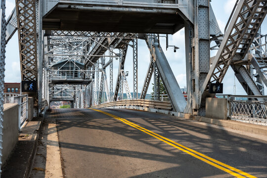 An empty roadway leads onto the historic steel truss structure of the Aerial Lift Bridge in Duluth, Minnesota