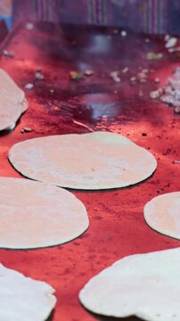 Preparing traditional mexican memelas on a griddle