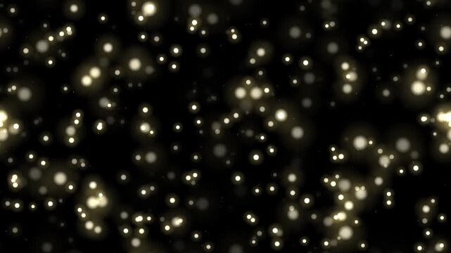 黒背景に無数の金色の光の粒が舞い上がる4Kシームレスループ 合成用オーバーレイ素材