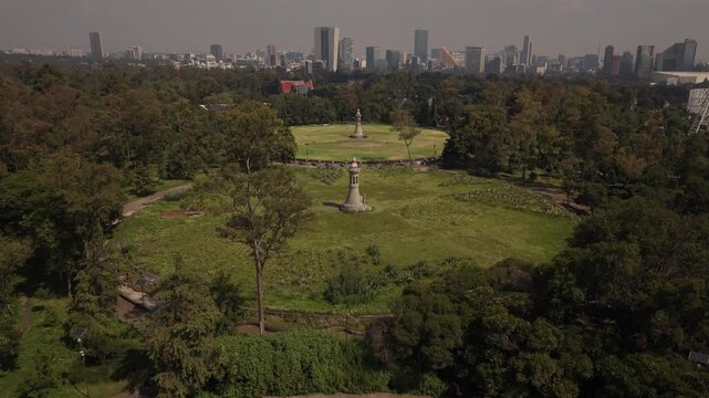 Aerial drone view of four historic water reservoirs in Chapultepec Park, Mexico City, with lush greenery on a sunny day