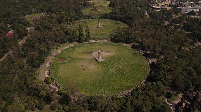 Smooth forward drone flight over C&aacute;rcamos de Dolores in Chapultepec, Mexico City, from a low elevated perspective with surrounding vegetation.