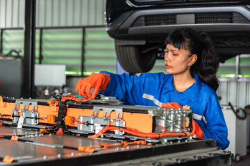 EV technicians inspect engineer inspecting electric vehicle battery