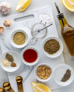 Various ingredients used for making a Greek chicken marinade.