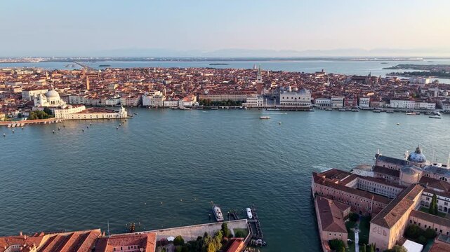 Aerial drone view of the Santa Maria della Salute church, the Doge's Palace and the waterfront across the water, Venice, Italy