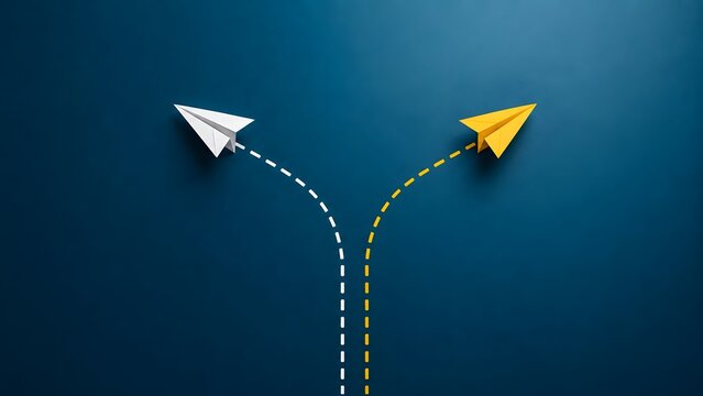 Yellow paper airplane changing direction and taking a different path from a white airplane on blue background