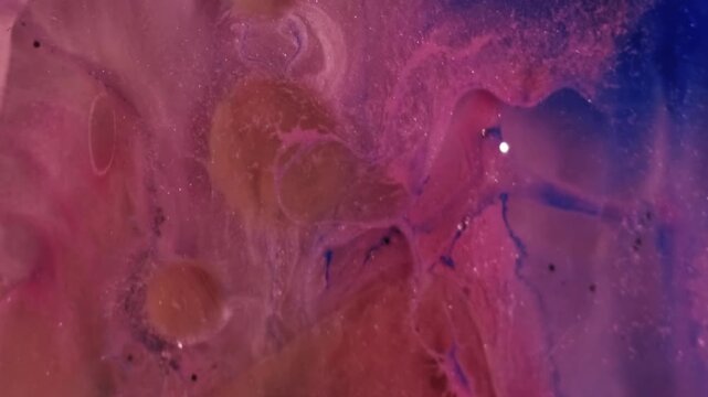 Oil bubbles pour. Shimmer fluid. Defocused pink blue color chemical wave glitter sequins liquid leaking on abstract acrylic art background.