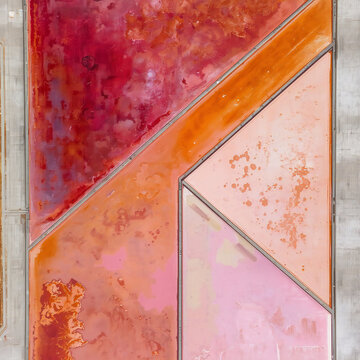 Abstract aerial view of colorful geometric salt ponds in pink and orange shades