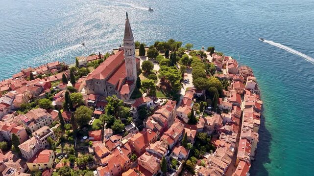 Aerial drone view of the church of St Euphemia and its tall bell tower above the rooftops of the old town, Rovinj, Croatia