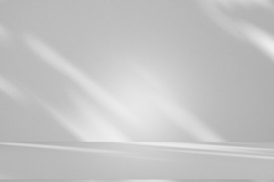 Wall interior background, studio and backdrops show products.with shadow from window color white and grey. background for text insertion and presentation product	
