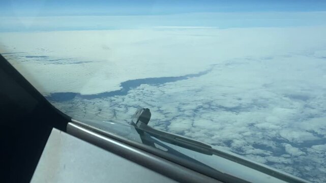 Timelapse from a pilot&rsquo;s point of view at cruise altitude over Greenland, showing the vast ice-covered landscape, glaciers, fjords and rugged Arctic terrain from the flight deck. Greenland contains th