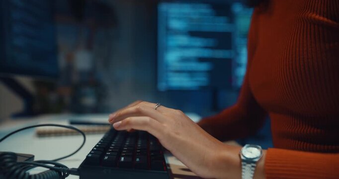 Close-up Black female programmer typing coding on keyboard working late in home office at night. Cybersecurity, AI algorithm, Network security, software developer, remote workspace overtime concept.