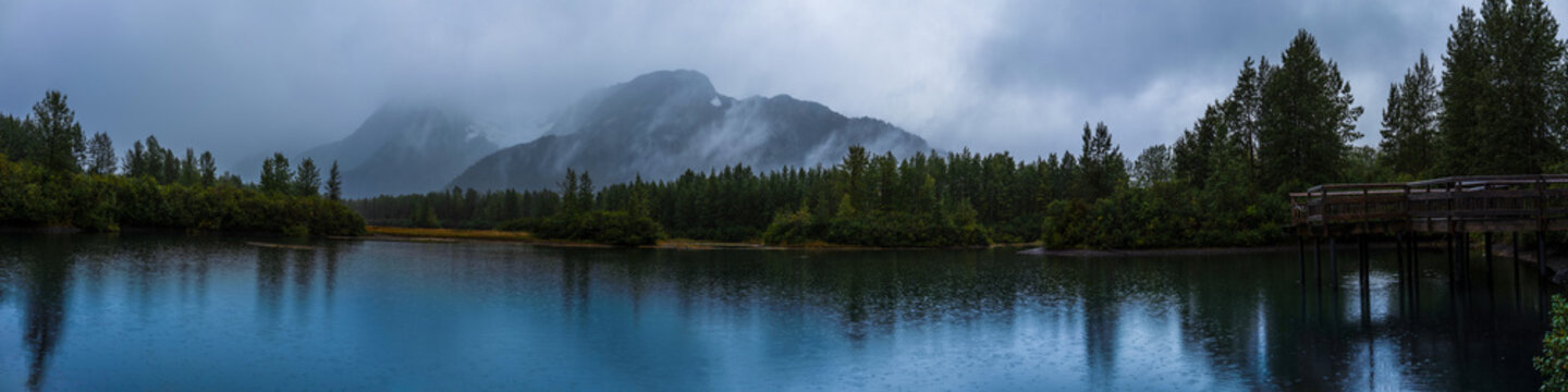Panoramic Alaska autumn landscape at Moose Flat Lake on a foggy rainy day in Girdwood south of Anchorage, USA