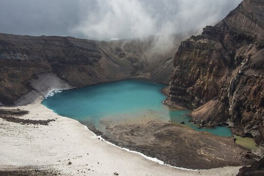 Steaming fumarole with crater lake on the Gorely volcano, Kamchatka, Russia