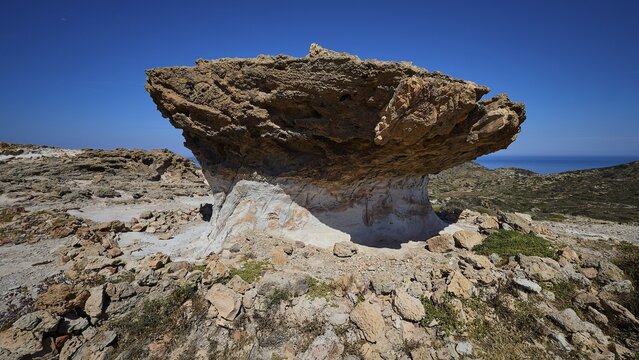 Distinctive rock formation under clear blue sky in a barren landscape, mushroom rocks, mushroom rock, bizarre rock formation, Skiadi, Kimolos, Cyclades, Greek Islands, Greece