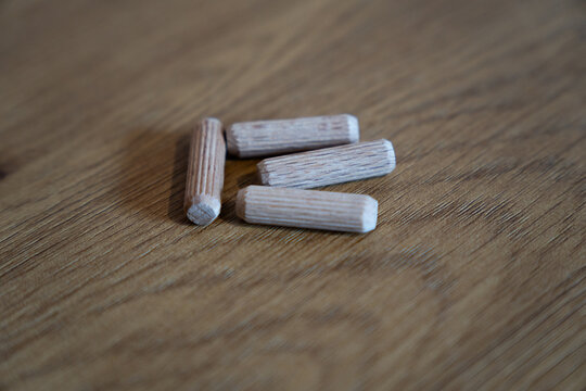 Wooden dowel pins for furniture assembly on wood surface