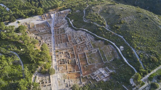 Drone shot, first morning light, Aerial view of an extensive ancient ruins site surrounded by green landscapes and vegetation, Kamiros, Archaeological site, Ancient city, Foundation of Doric Greeks, Rhodes, Dodecanese, Greek Islands, Greece