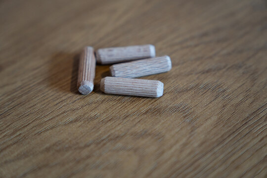 Wooden dowel pins for furniture assembly on wood surface