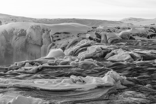 Icefall at the edge of the Godafoss waterfall at dawn, snow-covered landscape, black and white photo, Northern Iceland Eyestra, Iceland
