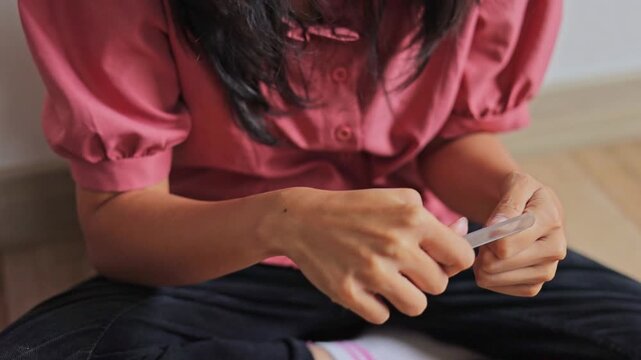Detailed shot of hands filing fingernails as part of beauty and self-care routine