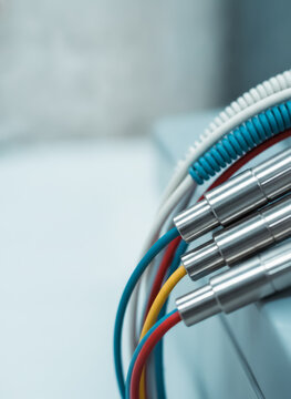 Colored wires connected to metallic cable connectors