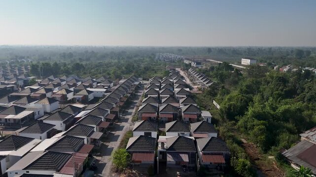 Rows of small suburban houses surrounded by dense trees in Banjarbaru South Kalimantan Indonesia