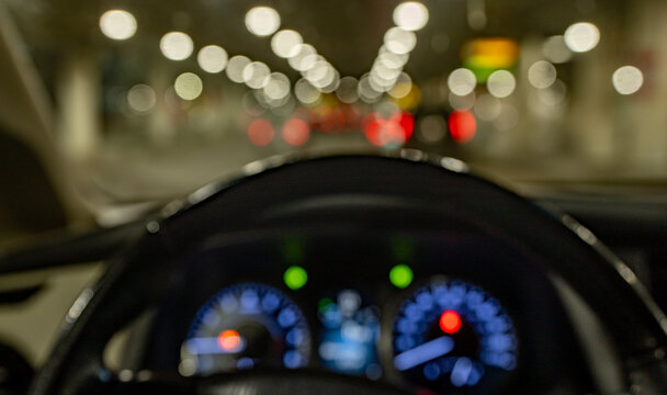 Wheel controls car during night driving. Wheel shows control on urban road. Wheel connects driver with vehicle motion. Wheel supports safety and navigation.