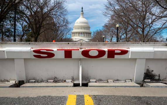 Stop security barrier near Capitol Hill. Government shutdown tension in Washington DC. Restricted access control near Capitol. Political budget stalemate in Congress.