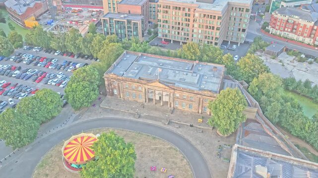 Female Prison of York Castle Museum features a Georgian sandstone facade, Ionic columns, pediment and broad steps beside Castle Green in York, England, drone descent.