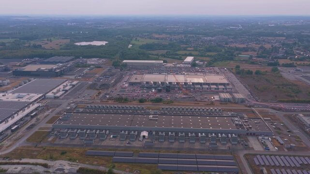 Aerial perspective of a massive hyperscale data center during its construction phase. This huge facility is central to cloud computing and ai