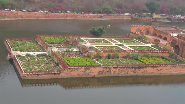 High angle static shot of the star shaped geometric Kesar Kyari garden floating on Maota Lake below Amer Fort in Jaipur, Rajasthan, India.