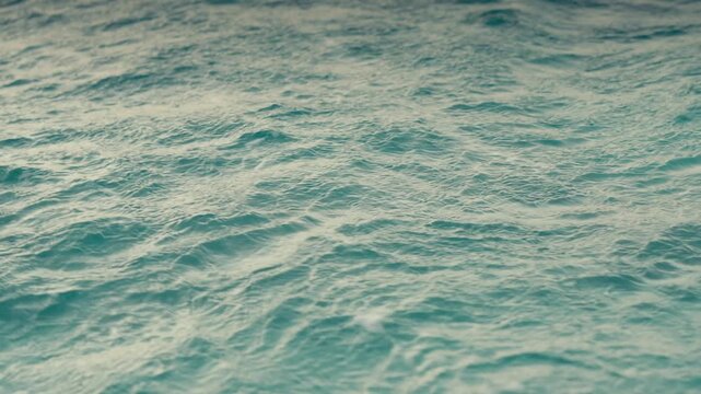 Clear Turquoise Water Surface with Ripples and Ocean Currents in Slow Motion