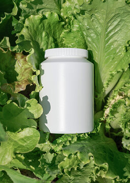 Mockup of white plastic bottle against backdrop of vibrant salad, symbolizing natural, healthy eating and organic supplements
