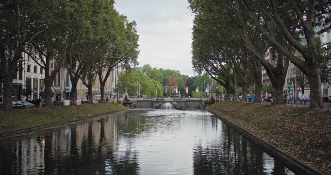 Dusseldorf Konigsallee canal Germany historic architecture presents an elegant boutique street with beautiful buildings, fashion shopping and a scenic urban landscape in Europe.
