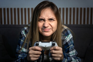 Close up hand of young woman playing games. Attractive beautiful sport girl gamer feeling happy and cheerful, enjoying using joystick game console at home © diy13