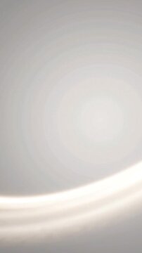 Glowing curved light beam creates elegant soft motion lines in this ethereal bright white background animation for modern video projects